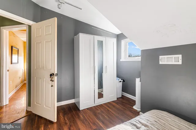 a view of bedroom with wooden floor