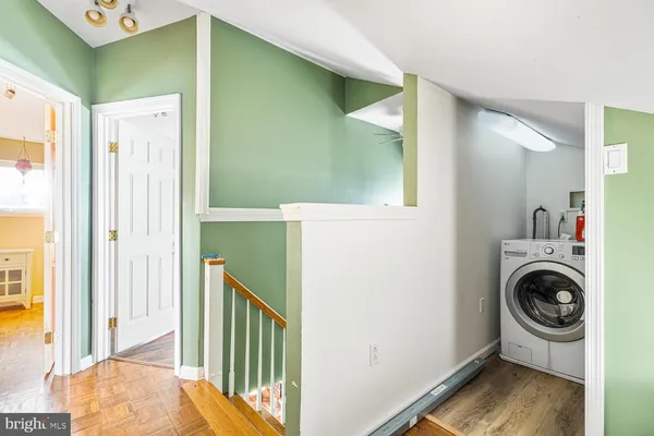 a view of a hallway with washer and dryer