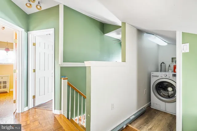a view of a hallway with washer and dryer
