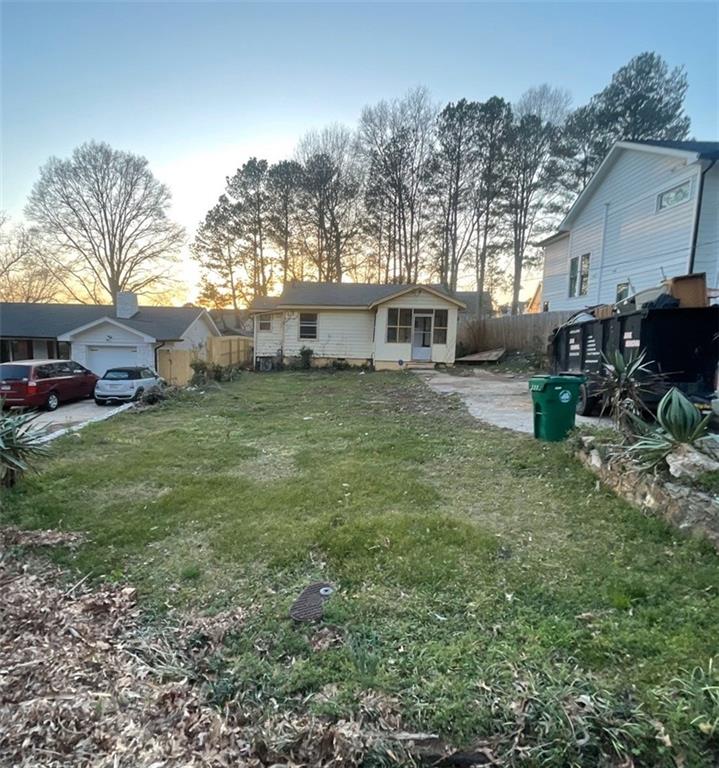 a backyard of a house with table and chairs