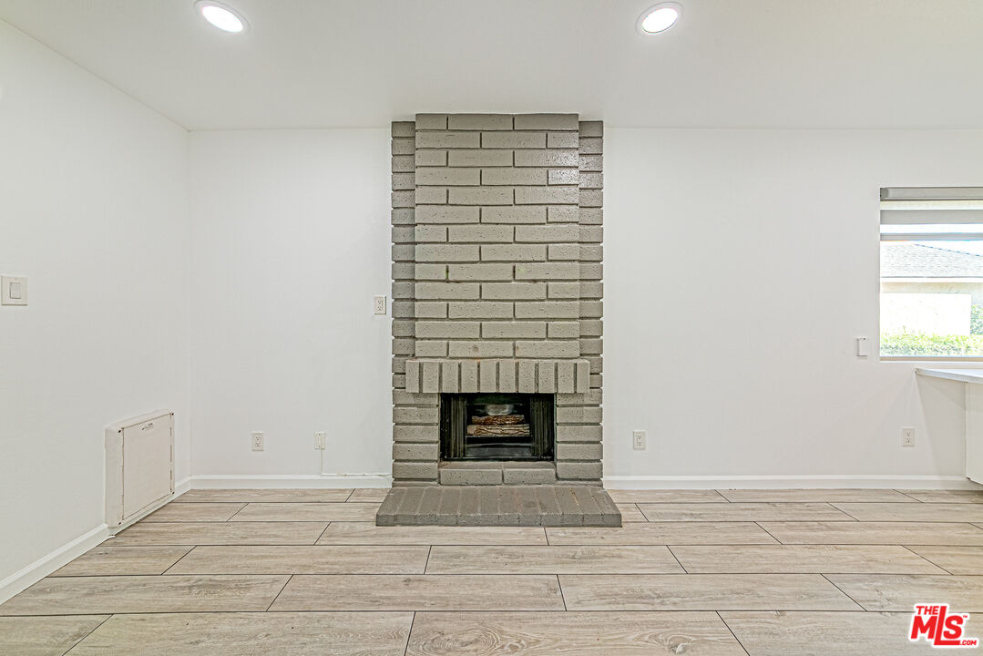 1941 Pine Drive La Habra, CA 90631 - Photo 11 of 35 a view of an empty room with a fireplace and a window