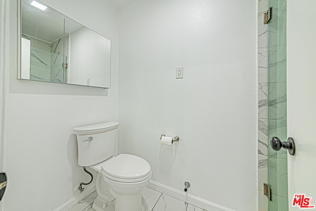 1941 Pine Drive La Habra, CA 90631 - Photo 18 of 35 a white toilet sitting next to a bathroom sink and vanity