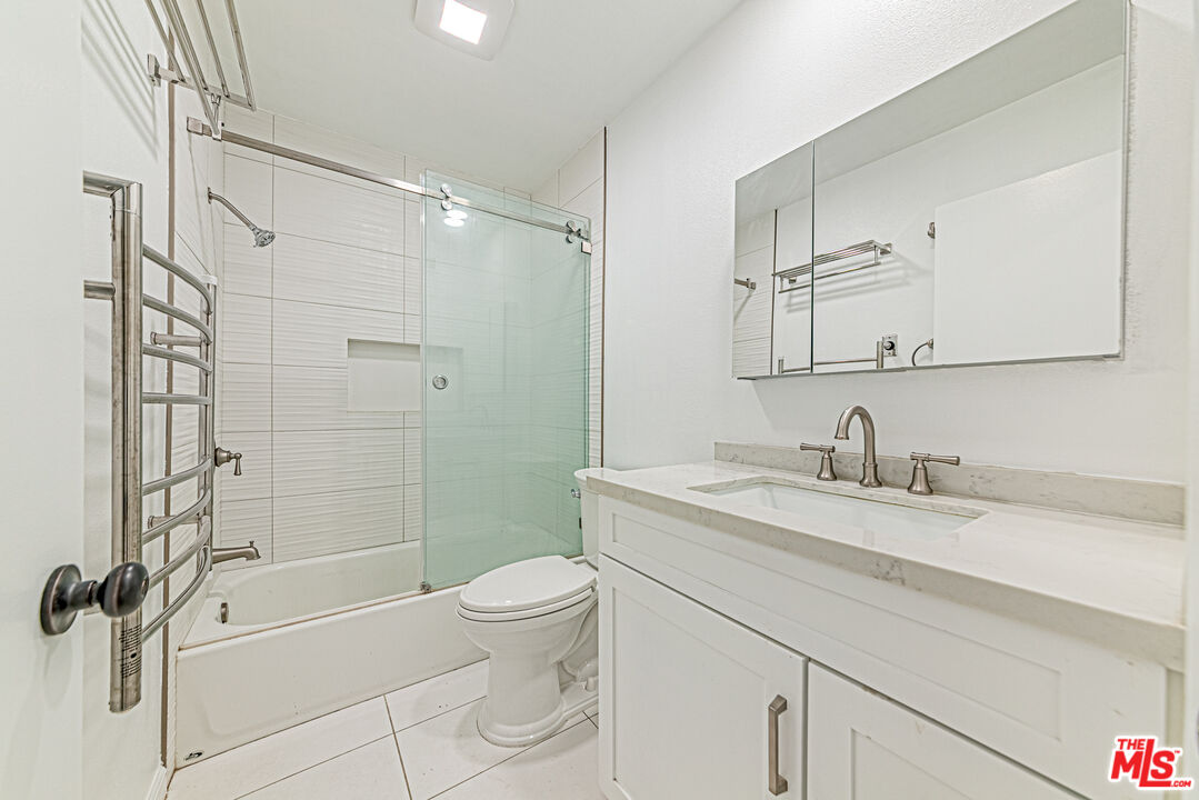 1941 Pine Drive La Habra, CA 90631 - Photo 23 of 35 a bathroom with a granite countertop sink a toilet and shower