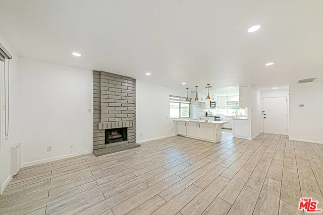 a view of kitchen with livingroom and fireplace