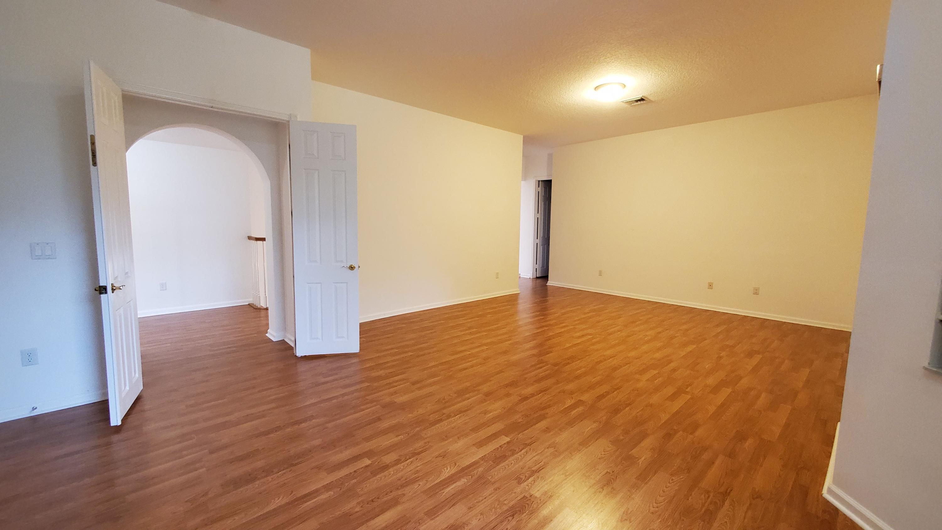 2252 Ridgewood Circle Royal Palm Beach, FL 33411 - Photo 13 of 40 wooden floor in an empty room with a window