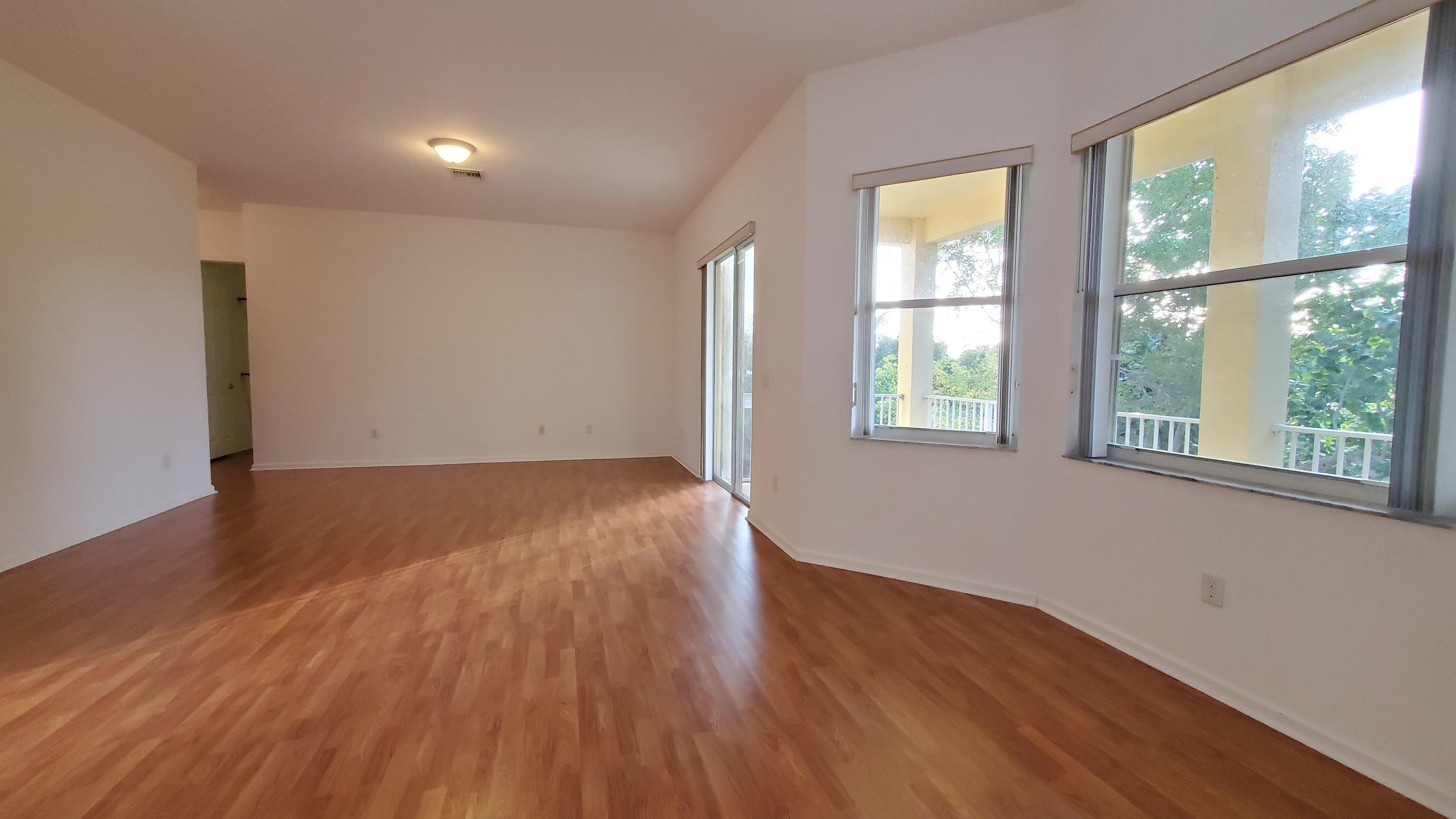 2252 Ridgewood Circle Royal Palm Beach, FL 33411 - Photo 14 of 40 an empty room with wooden floor and windows