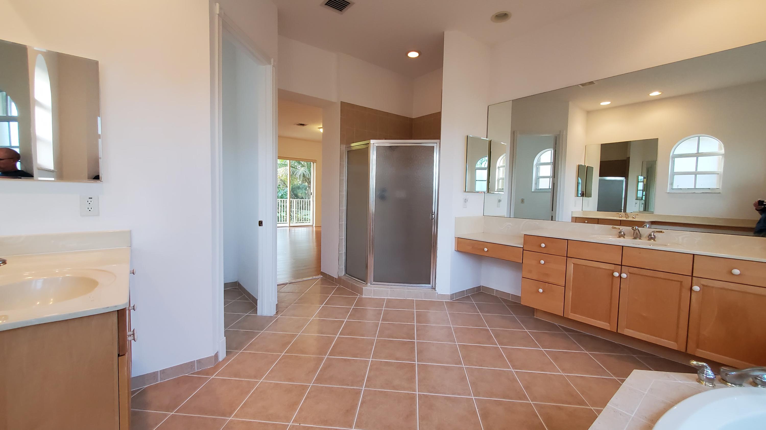 2252 Ridgewood Circle Royal Palm Beach, FL 33411 - Photo 18 of 40 a bathroom with a sink a toilet and mirror