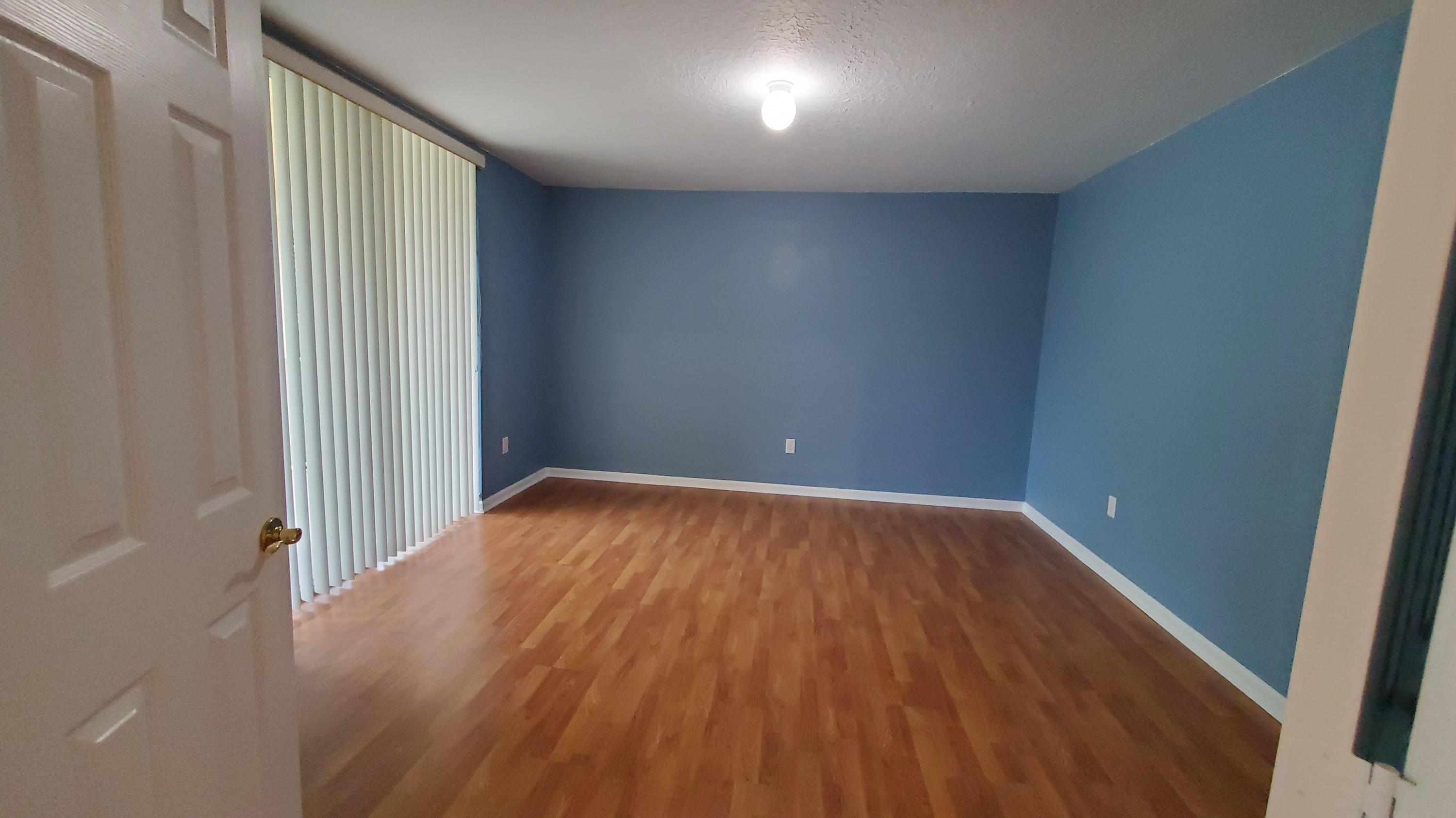 2252 Ridgewood Circle Royal Palm Beach, FL 33411 - Photo 20 of 40 an empty room with wooden floor and windows
