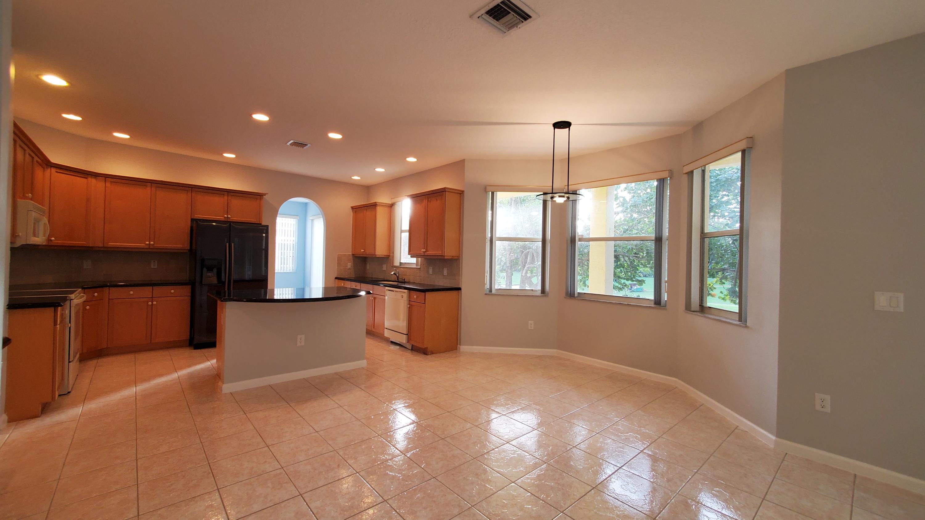 2252 Ridgewood Circle Royal Palm Beach, FL 33411 - Photo 2 of 40 a view of kitchen with refrigerator and window