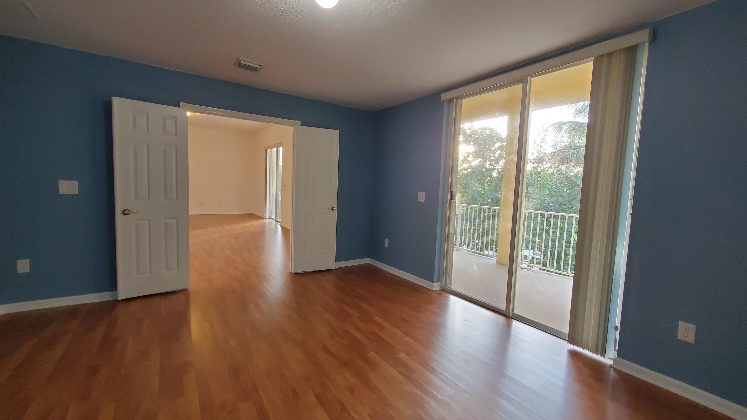 2252 Ridgewood Circle Royal Palm Beach, FL 33411 - Photo 21 of 40 wooden floor in an empty room with a window