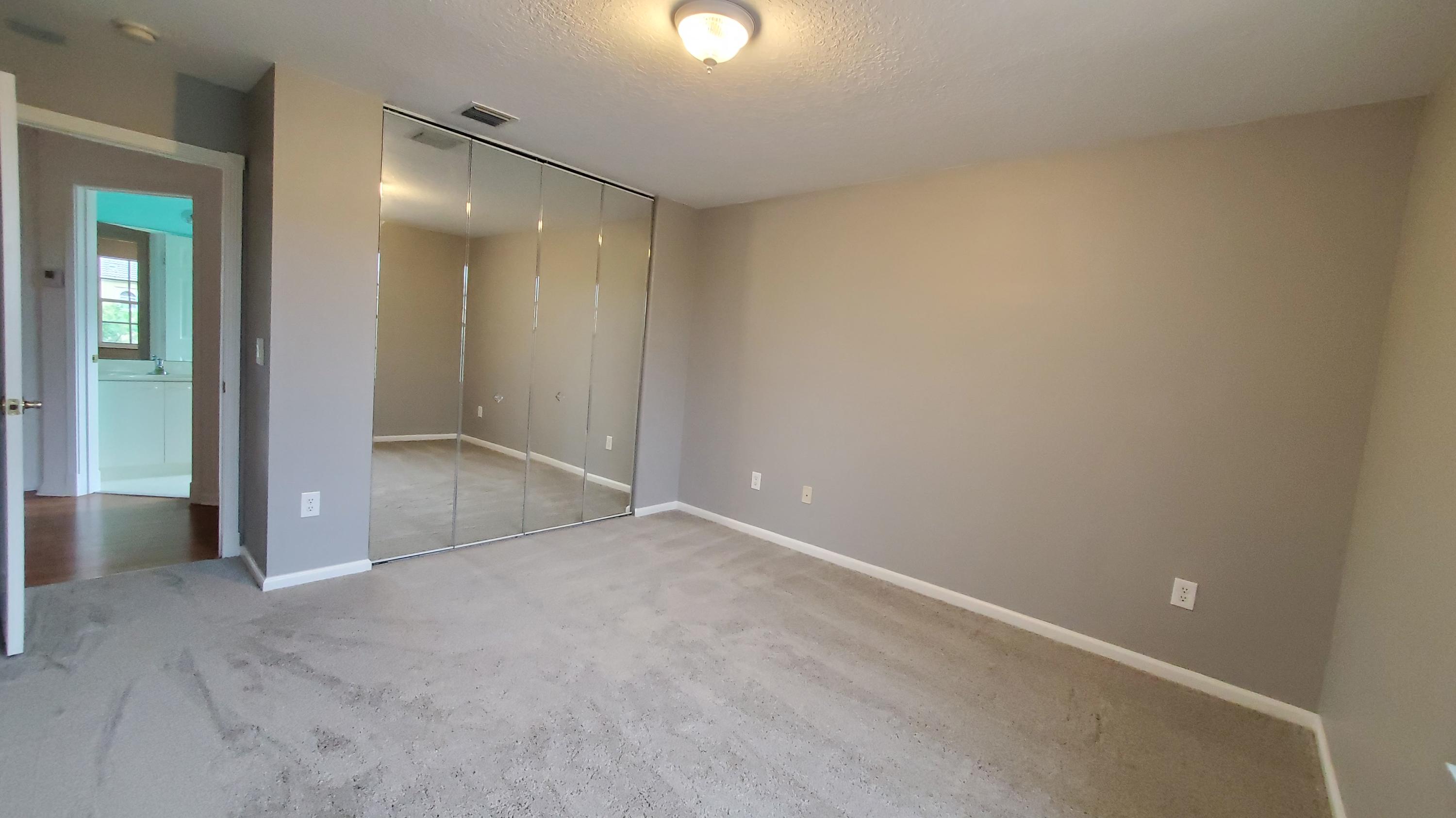 2252 Ridgewood Circle Royal Palm Beach, FL 33411 - Photo 27 of 40 an empty room with closet and mirror