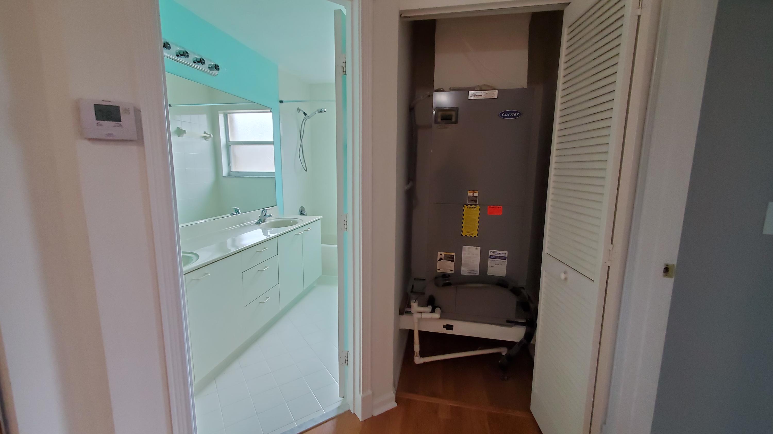 2252 Ridgewood Circle Royal Palm Beach, FL 33411 - Photo 29 of 40 a bathroom with a sink and a mirror