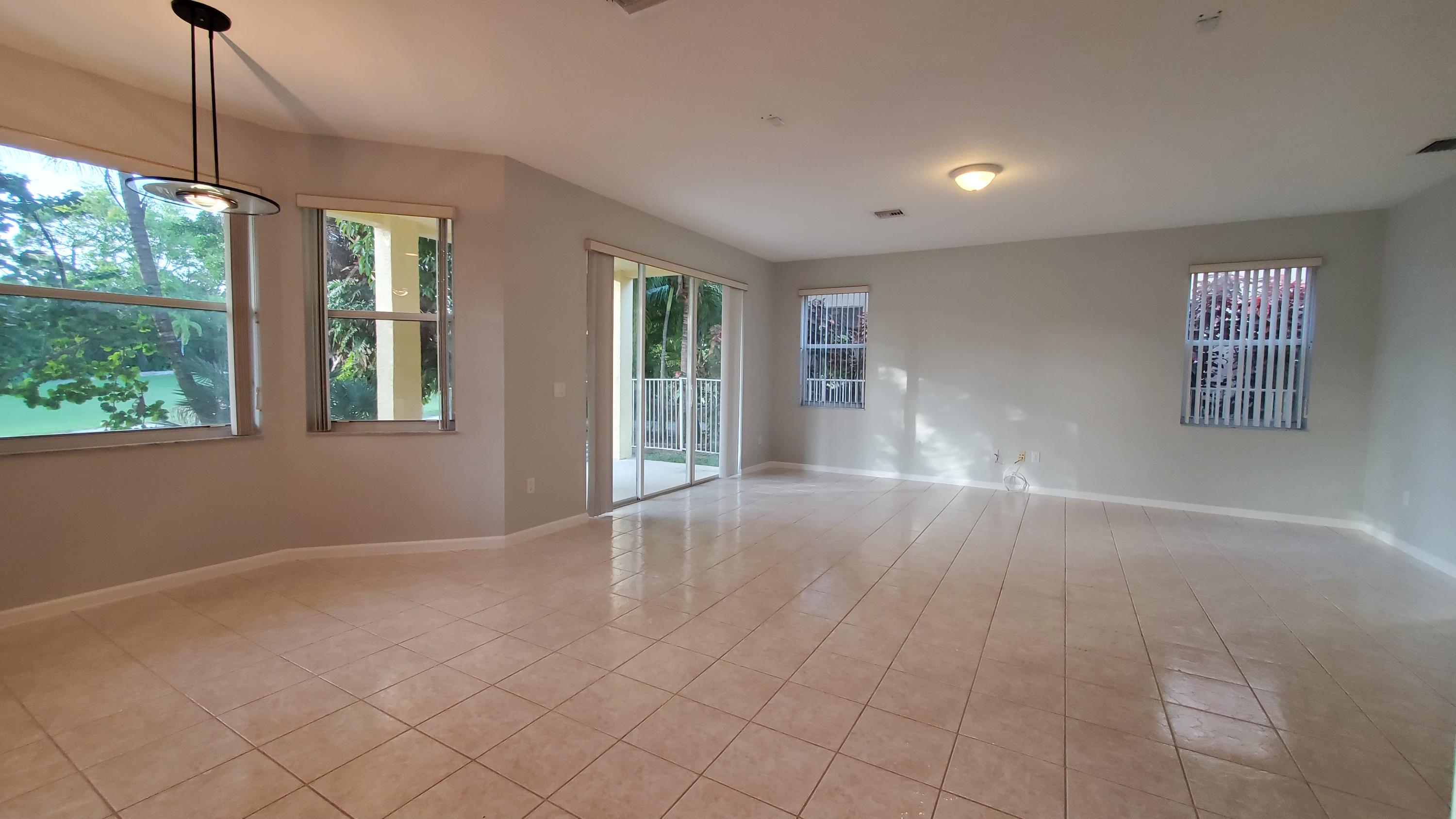 2252 Ridgewood Circle Royal Palm Beach, FL 33411 - Photo 6 of 40 a view of an empty room with a window