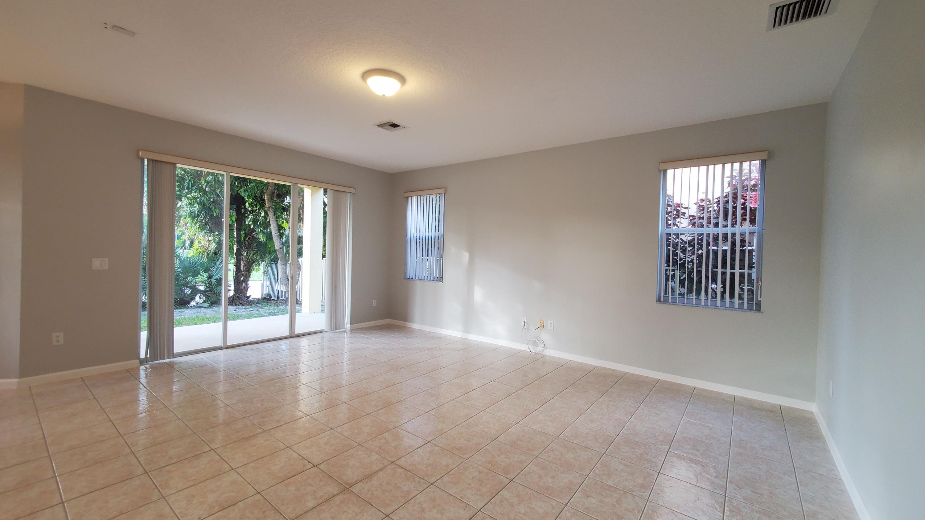 2252 Ridgewood Circle Royal Palm Beach, FL 33411 - Photo 7 of 40 a view of an empty room with a window
