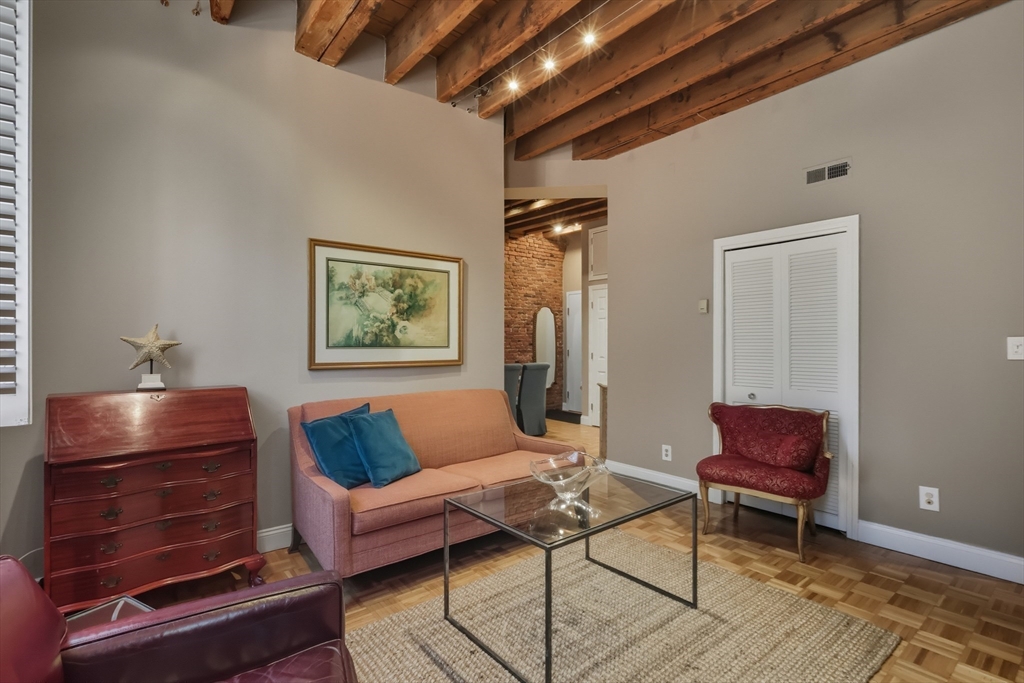 130 Fulton Street, Unit 7 Boston, MA 02109 - Photo 5 of 24 a living room with furniture and a rug