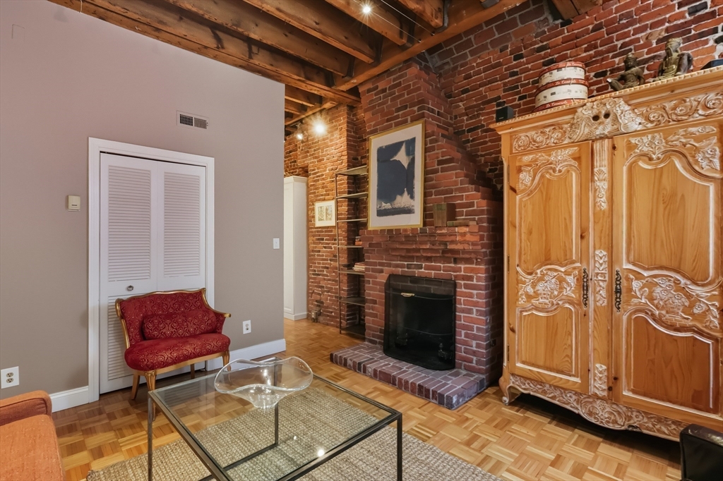 130 Fulton Street, Unit 7 Boston, MA 02109 - Photo 6 of 24 a living room with furniture and a fireplace