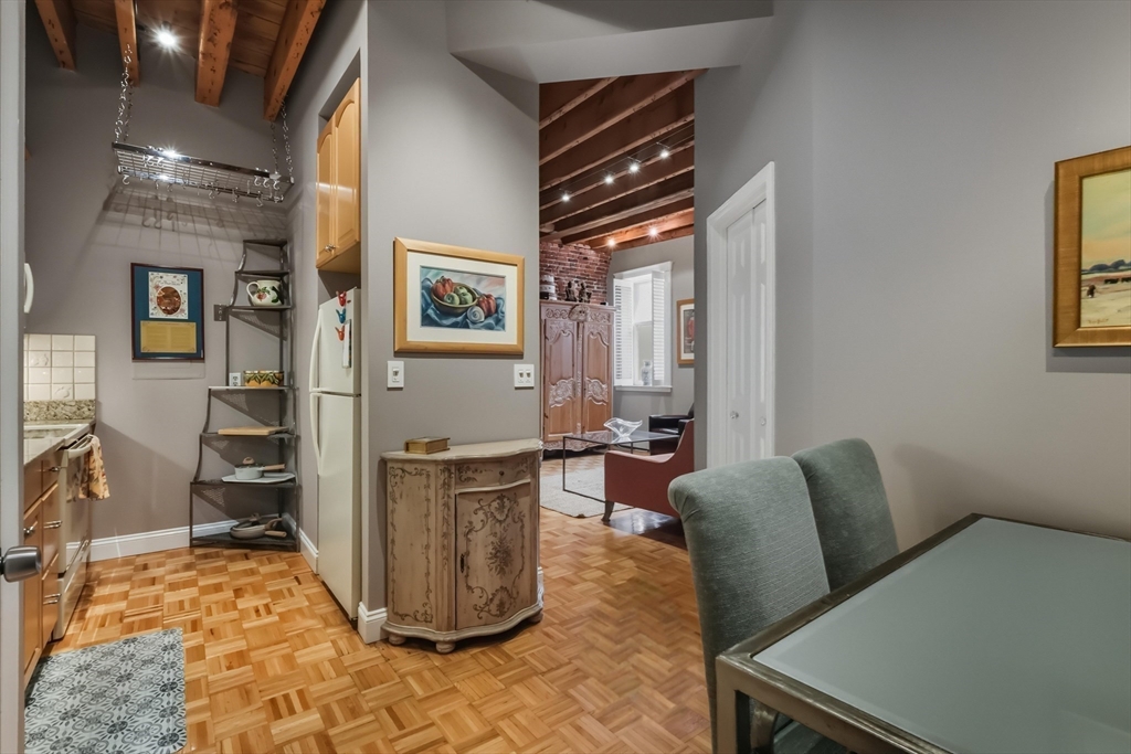 130 Fulton Street, Unit 7 Boston, MA 02109 - Photo 7 of 24 a living room with furniture a flat screen tv and a table