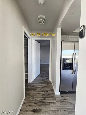 a view of a hallway view with wooden floor and staircase