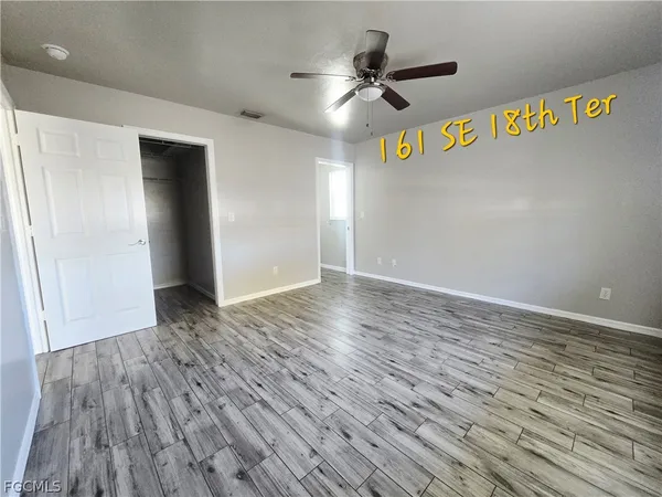 a view of an empty room and wooden floor