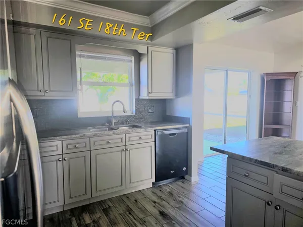 a kitchen with sink and cabinets