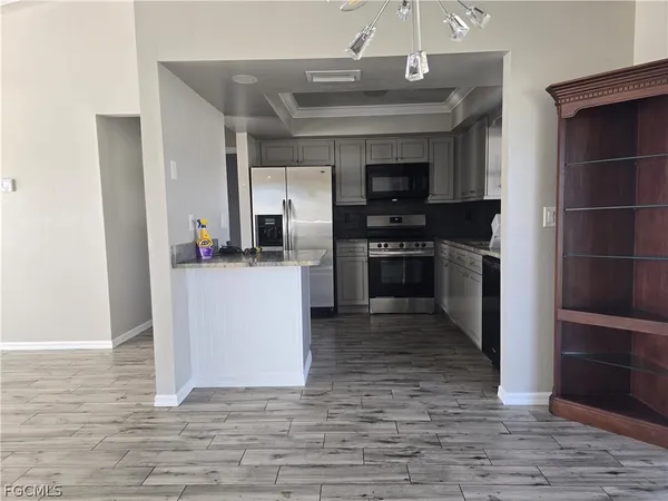 a kitchen with granite countertop a stove and a refrigerator