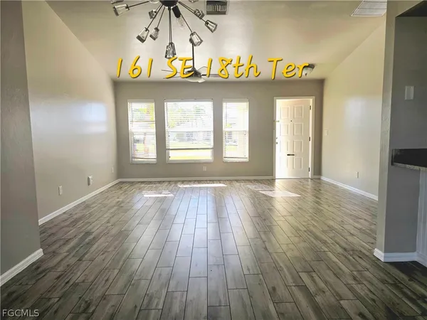 a view of an entryway with wooden floor