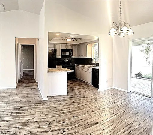 a view of a kitchen with kitchen island a counter top space and stainless steel appliances