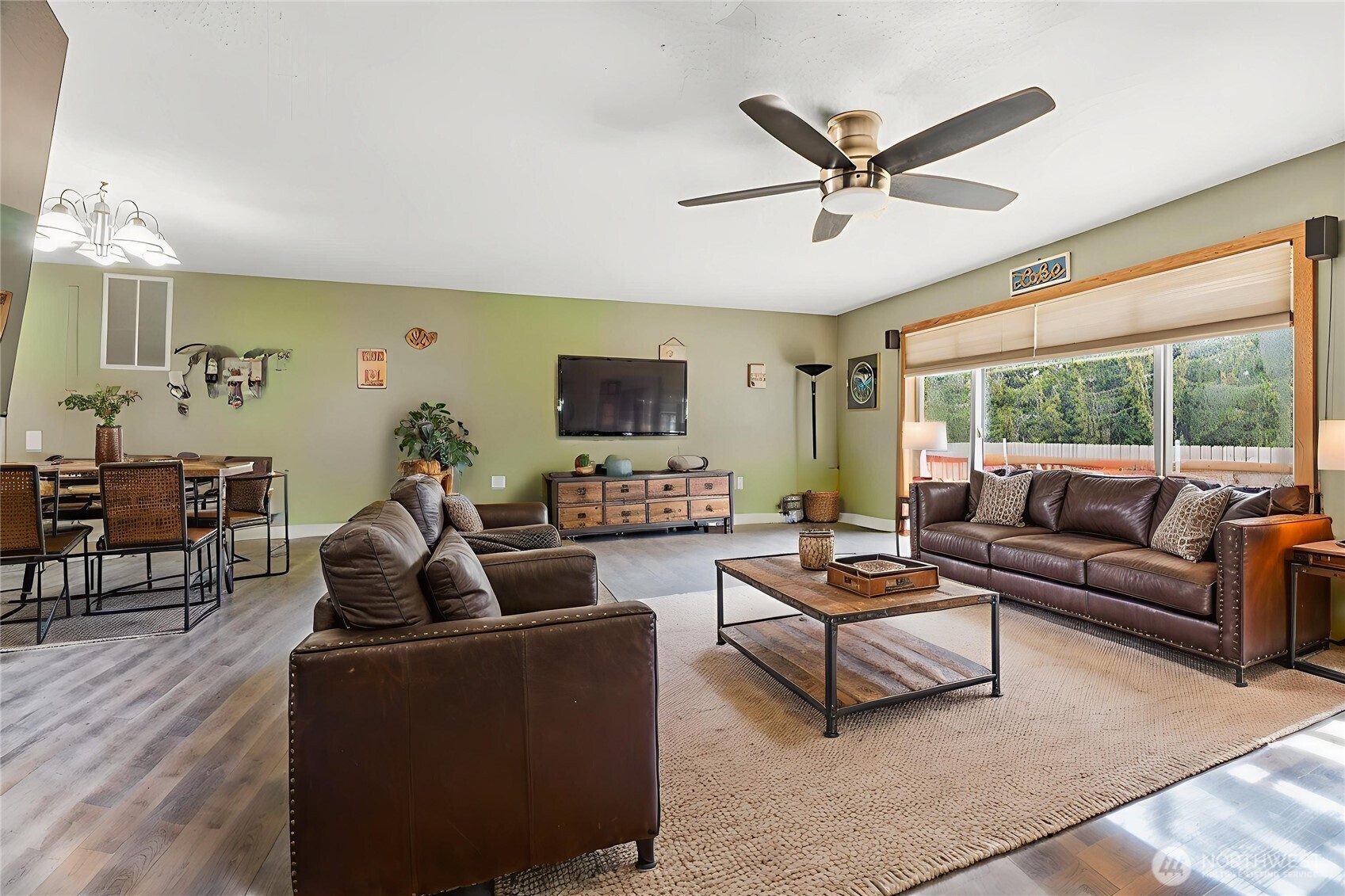 114 Mason Road Silverlake, WA 98645 - Photo 5 of 29 a living room with furniture a ceiling fan a fireplace and a large window