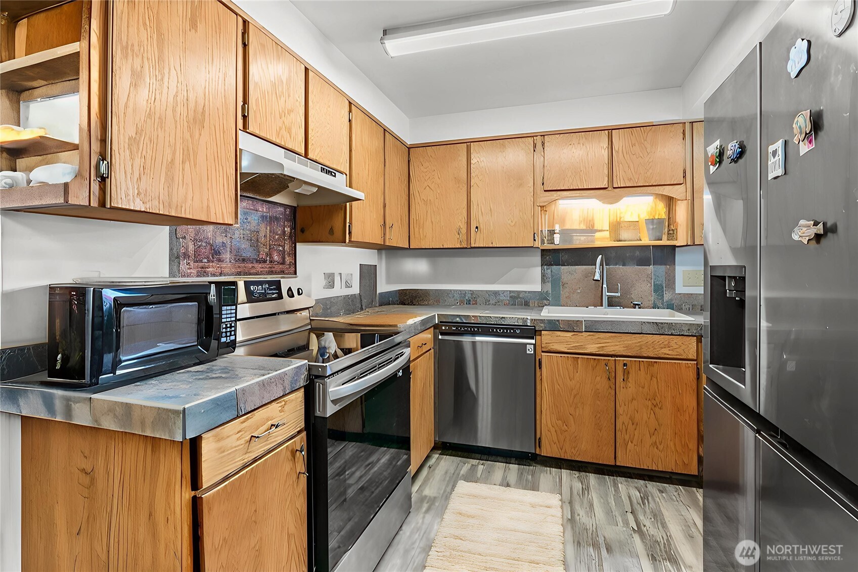 114 Mason Road Silverlake, WA 98645 - Photo 8 of 29 a kitchen with stainless steel appliances granite countertop a stove a sink and a microwave