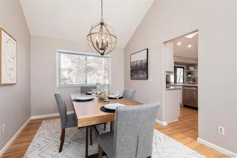 a dining room with furniture a chandelier and window