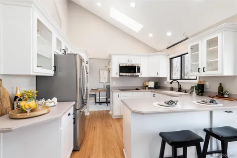 a kitchen with stainless steel appliances a refrigerator and a stove
