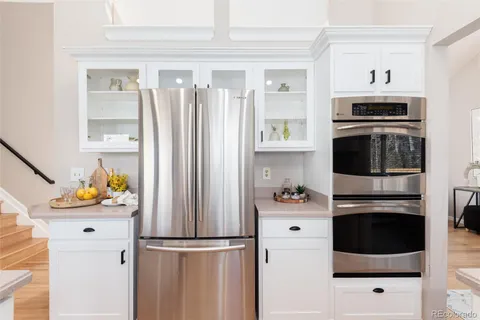 a kitchen with stainless steel appliances a refrigerator a sink a stove and cabinets