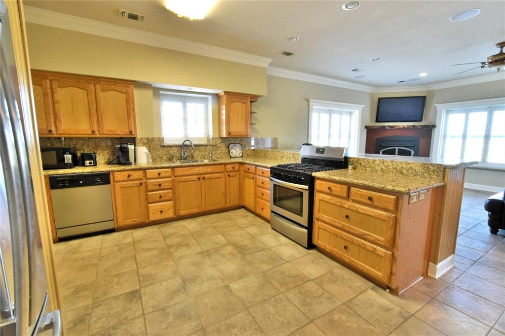 108 Barham Lane Bridgeport, TX 76426 - Photo 16 of 30 a kitchen with stainless steel appliances granite countertop a sink and cabinets