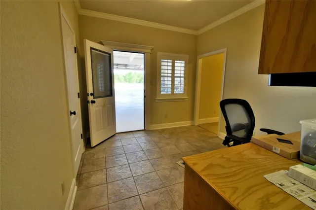 a spacious bedroom with a bed and wooden floor