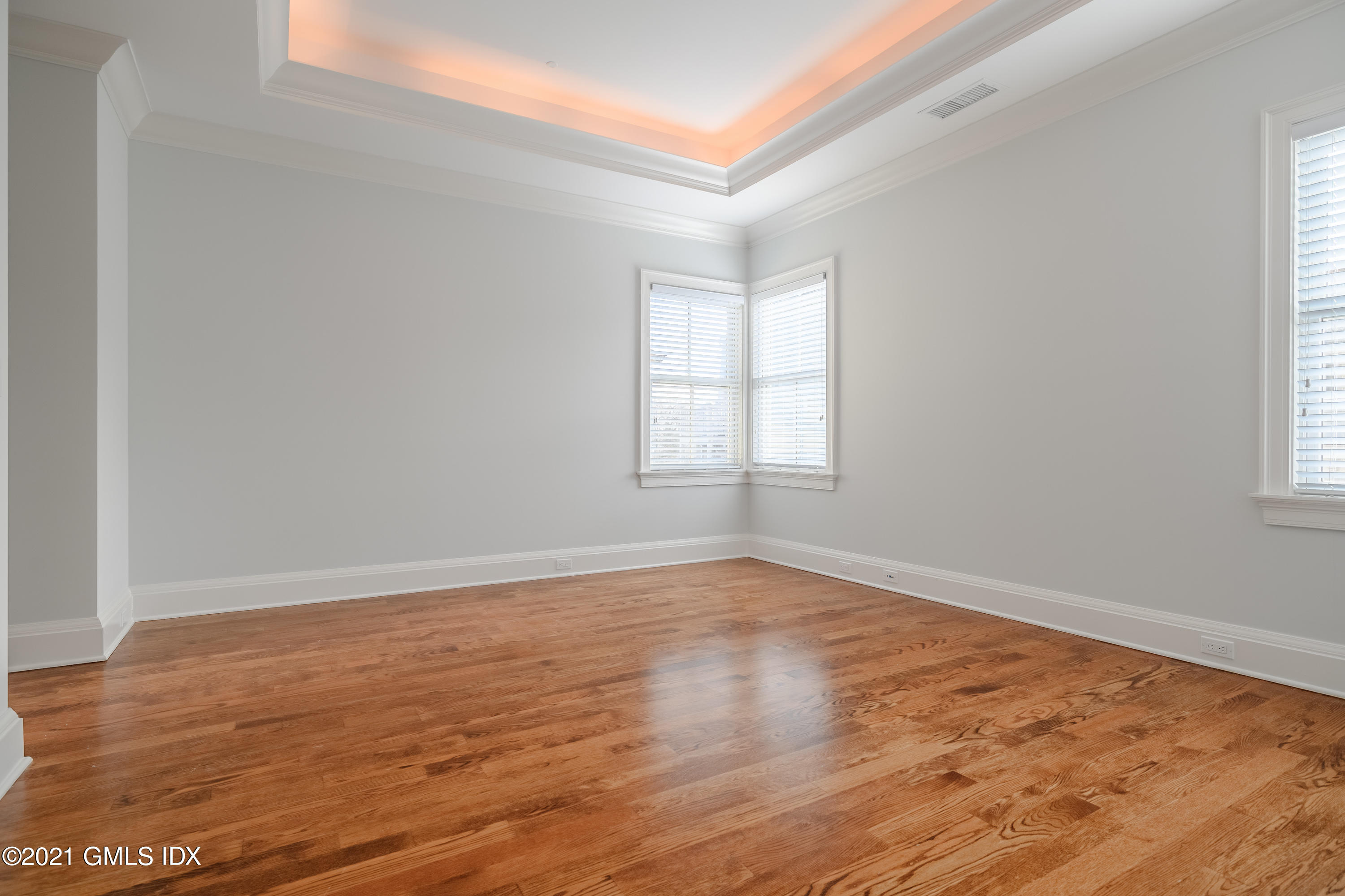 623 Steamboat Road, Unit A Greenwich, CT 06830 - Photo 22 of 43 an empty room with wooden floor and windows