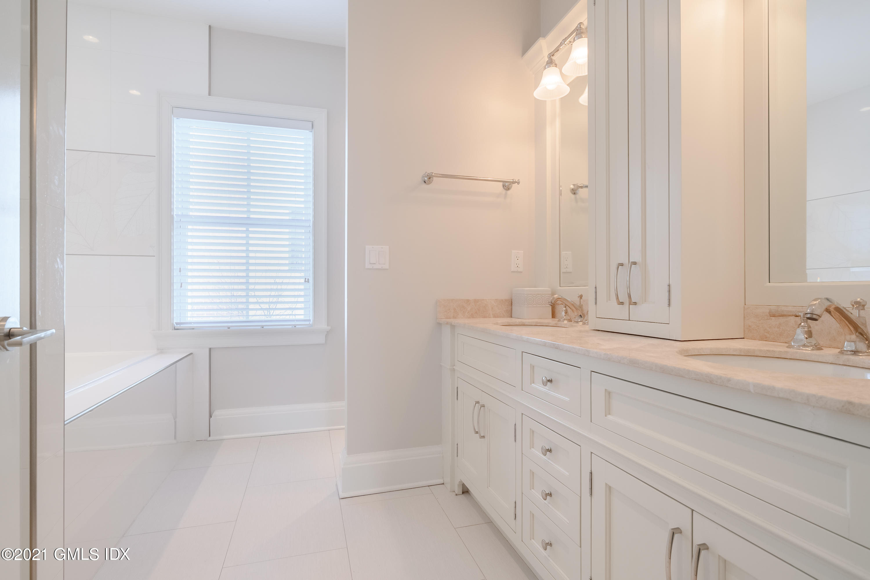 623 Steamboat Road, Unit A Greenwich, CT 06830 - Photo 25 of 43 a bathroom with double sink and a window