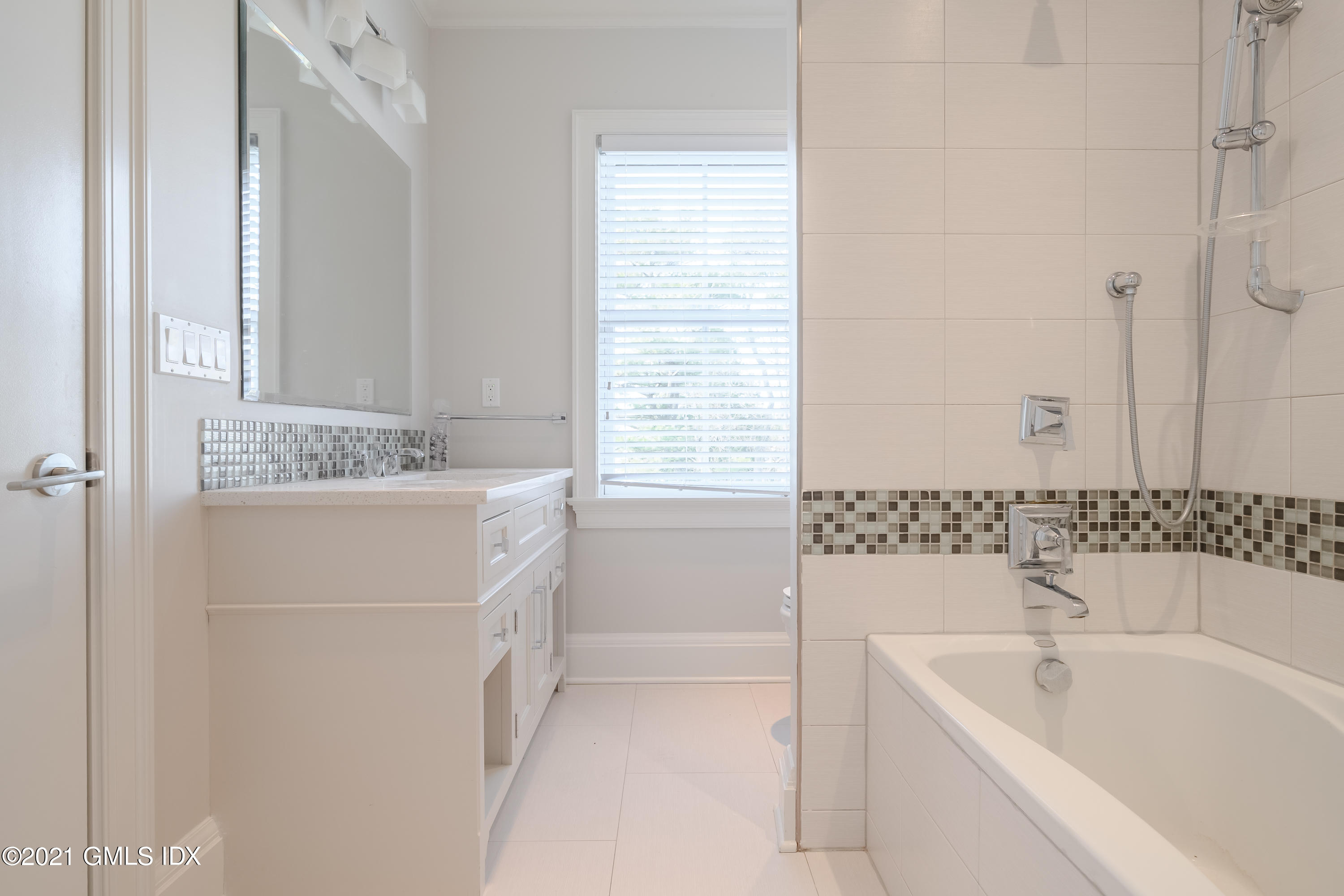 623 Steamboat Road, Unit A Greenwich, CT 06830 - Photo 30 of 43 a bathroom with a tub sink and mirror