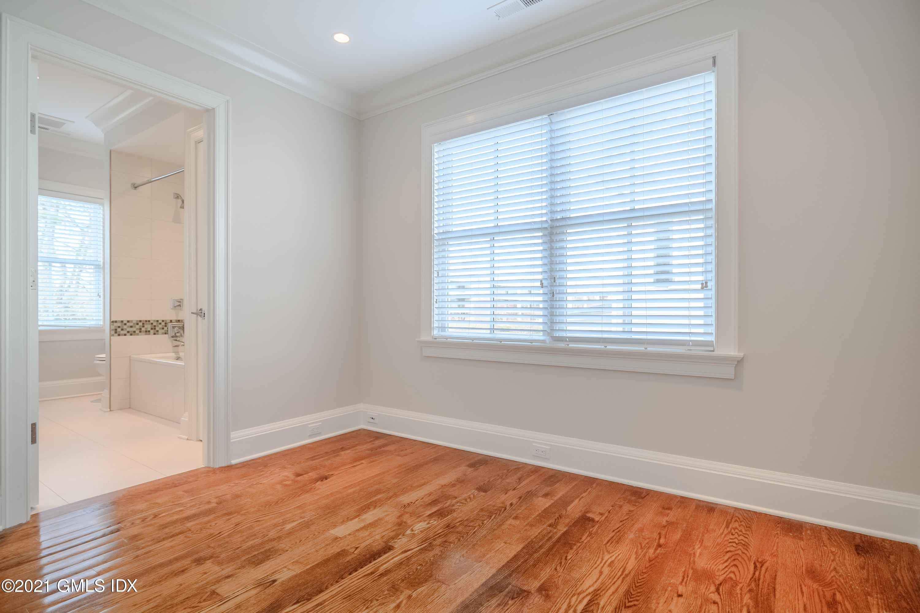 623 Steamboat Road, Unit A Greenwich, CT 06830 - Photo 31 of 43 an empty room with wooden floor and windows