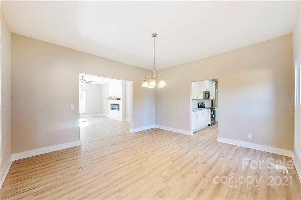 313 Old Williams Road Wingate, NC 28174 - Photo 11 of 46 a view of a kitchen with wooden floor and a large window