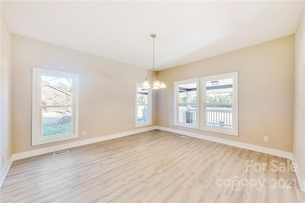 313 Old Williams Road Wingate, NC 28174 - Photo 12 of 46 a view of an empty room with wooden floor and a window