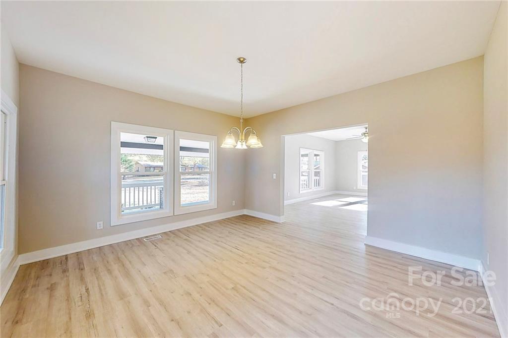 313 Old Williams Road Wingate, NC 28174 - Photo 17 of 46 a view of an empty room with window and wooden floor