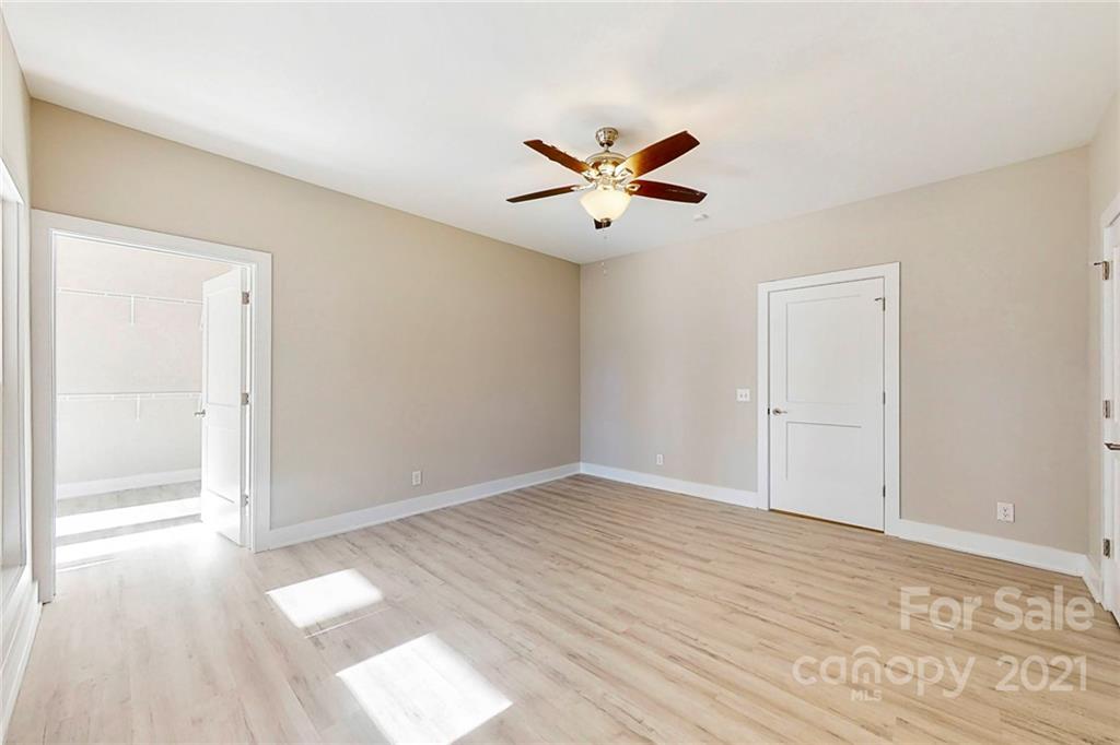 313 Old Williams Road Wingate, NC 28174 - Photo 23 of 46 a view of empty room with wooden floor and fan