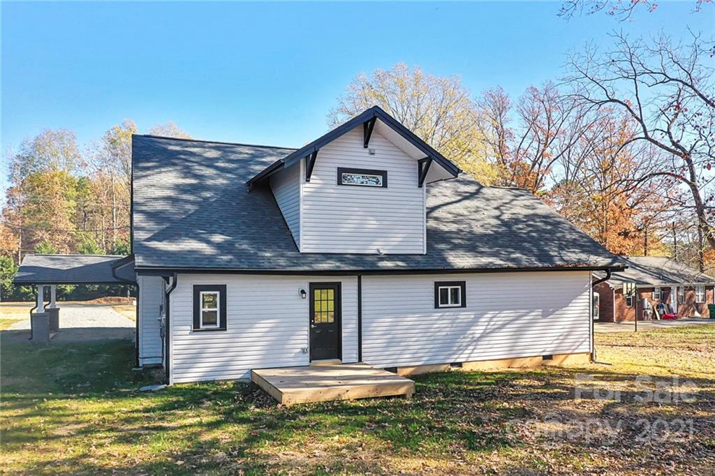 313 Old Williams Road Wingate, NC 28174 - Photo 25 of 46 a front view of house with yard and trees in the background