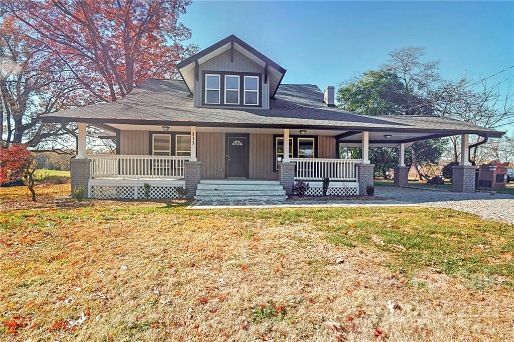 313 Old Williams Road Wingate, NC 28174 - Photo 3 of 46 a front view of a house with garden