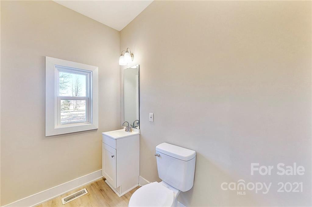 313 Old Williams Road Wingate, NC 28174 - Photo 31 of 46 a bathroom with a toilet sink and a mirror