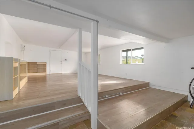 a view of a hallway view with wooden floor and staircase