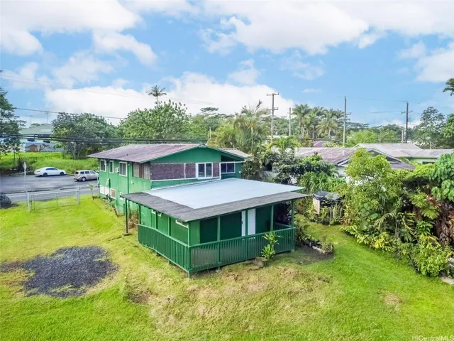 an aerial view of a house with swimming pool and furniture