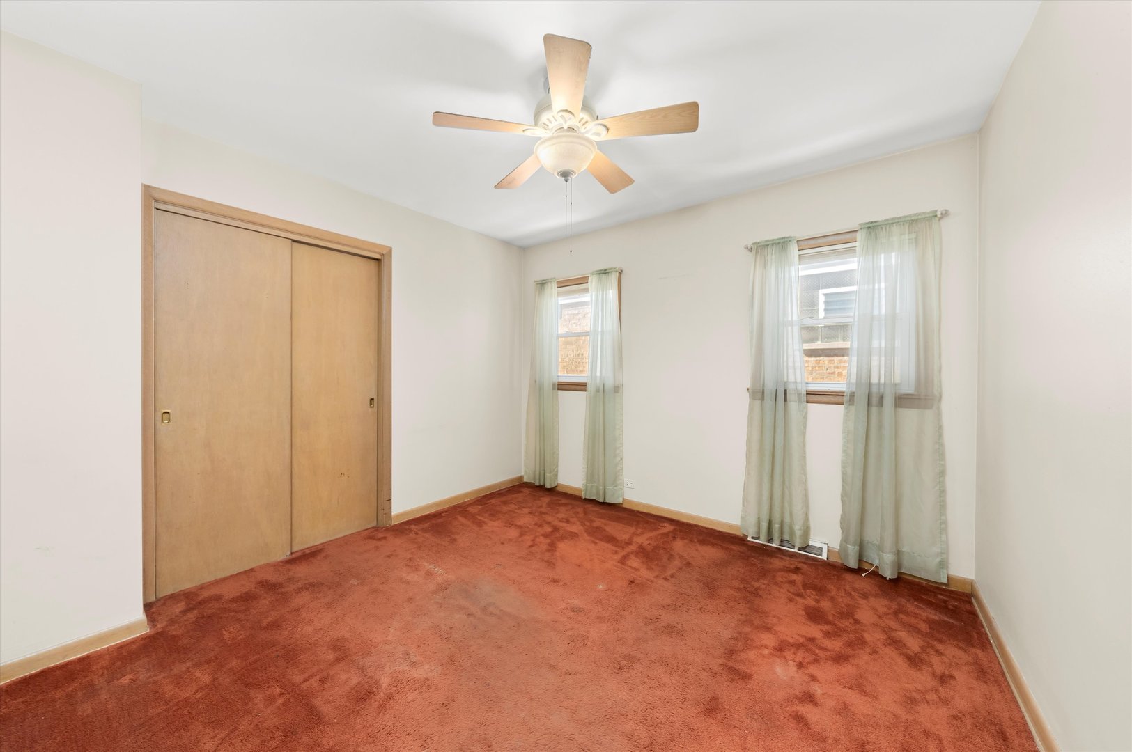 6511 West 63rd Place Chicago, IL 60638 - Photo 7 of 12 a view of a room with a ceiling fan and wooden floor