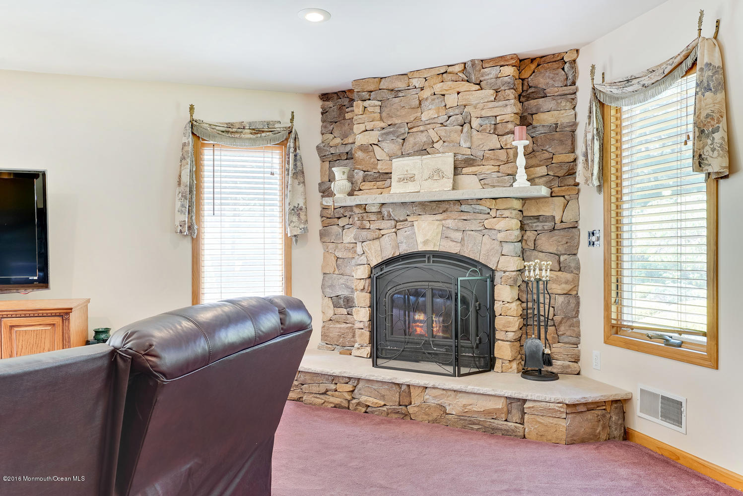 370 Cook Road Jackson, NJ 08527 - Photo 18 of 35 a living room with furniture and a fireplace