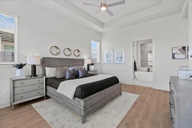 a bedroom with a large bed and a chandelier